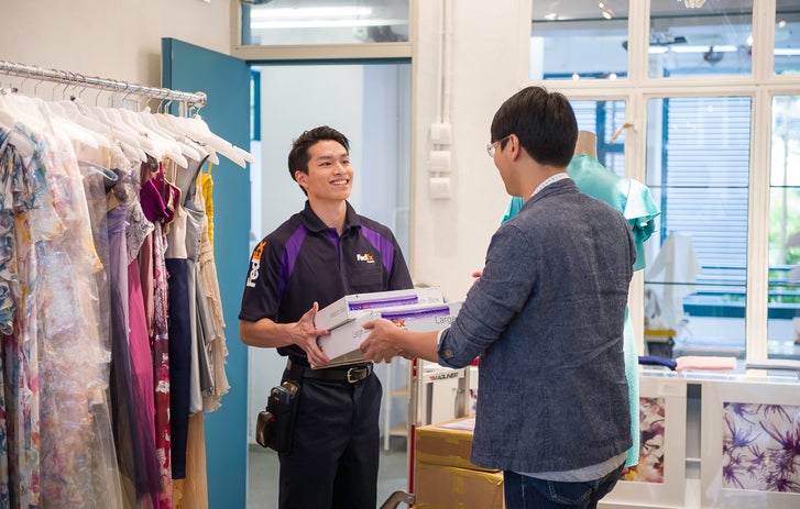 a fedex driver handing over a package