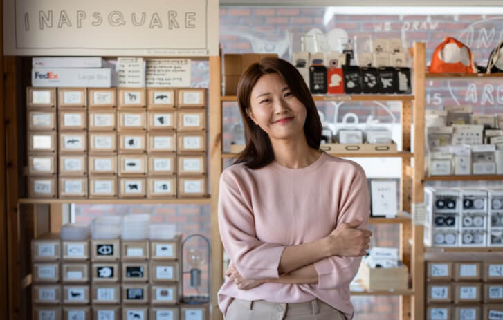 A woman smiling with her arms crossed